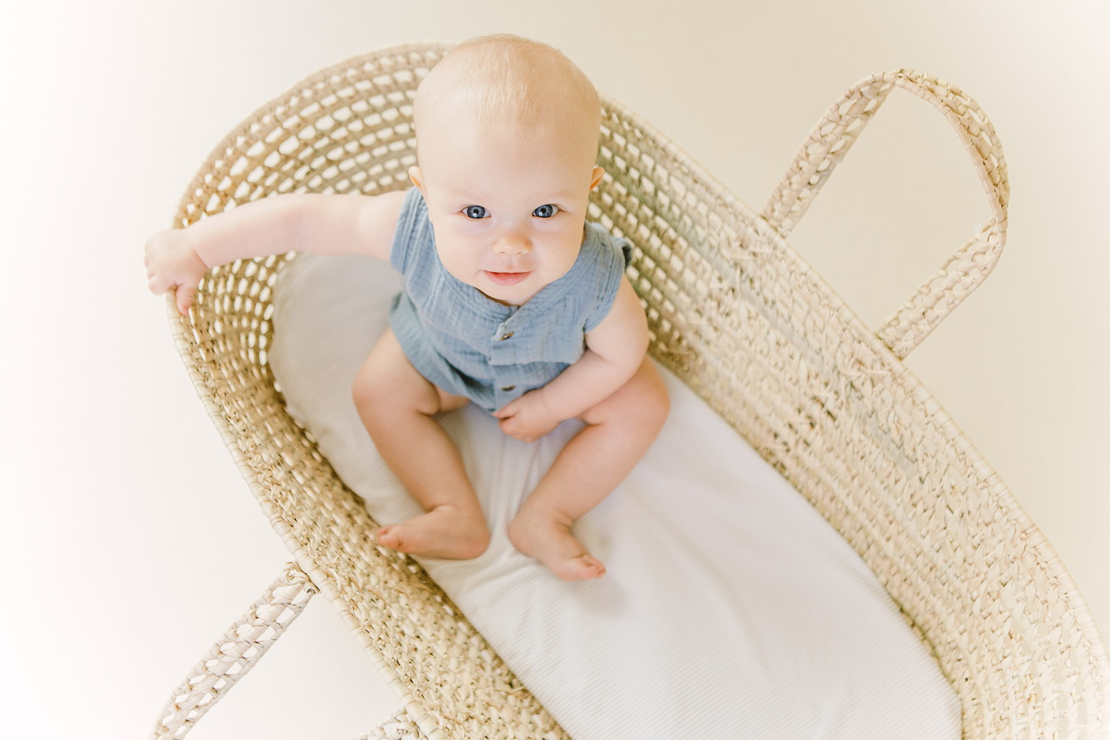 Six-month-old baby sitting and smiling in studio – Meridian, Idaho.